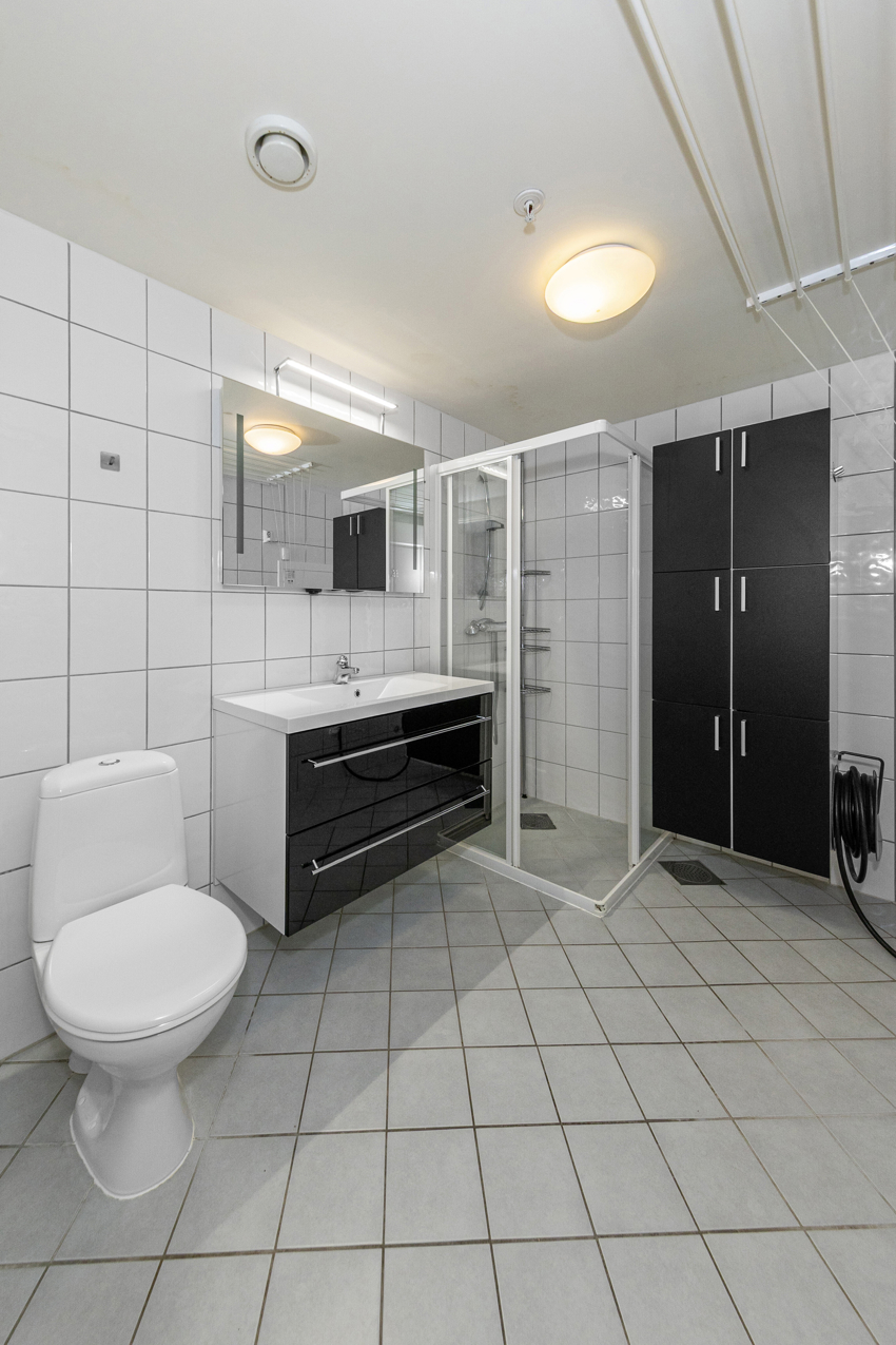 Bad er flislagt med dusjhjørne